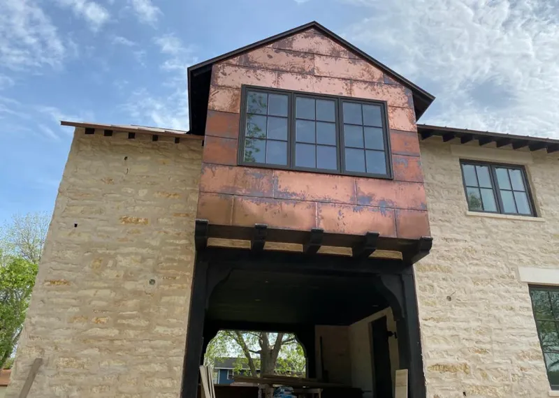 Copper metal panel facade on a stone building for Skylight Installation in East Palo Alto